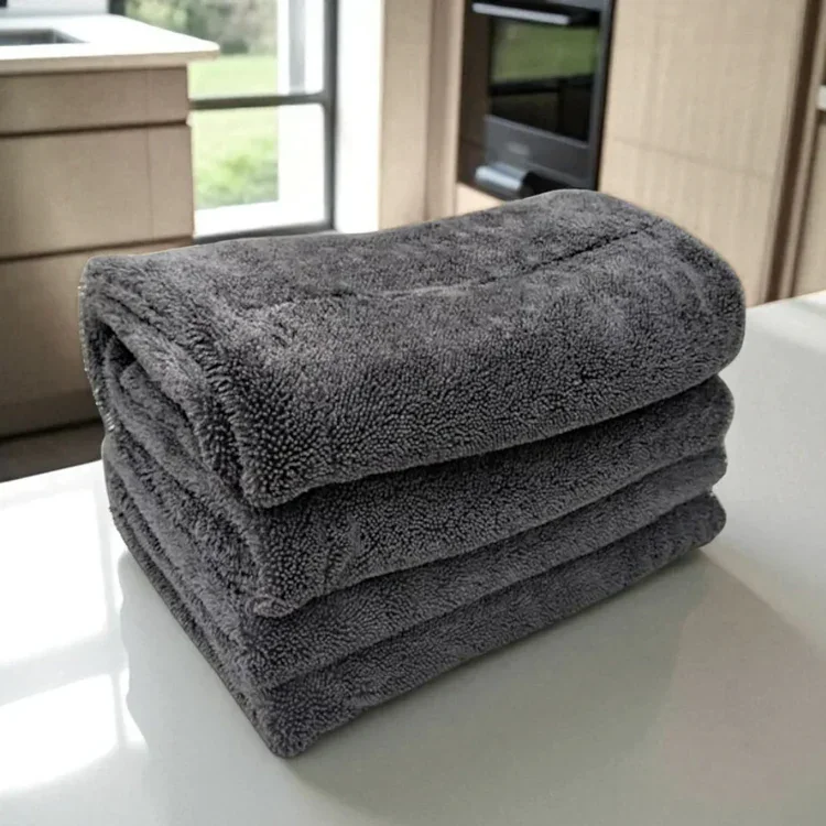 A stack of dark grey KoalaCloth cleaning cloths